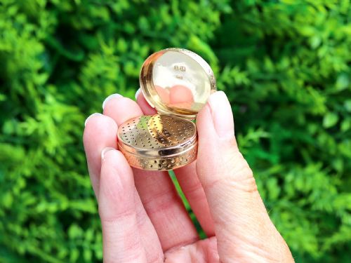 fig 3. An oval antique 18ct yellow gold vinaigrette featuring an engine-turned pattern with polished circular dot accents.