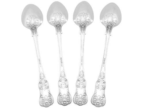 fig 1. Four polished sterling silver gravy spoons displaying intricate Queens pattern scrollwork and shell motifs along their handles, arranged side by side against a white background.