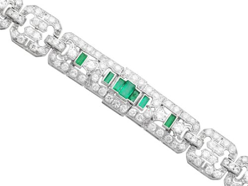 fig 5. An Art Deco platinum strap bracelet featuring geometric links set with diamonds and green accent emeralds.