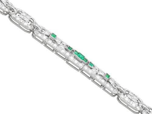 fig 6. An Art Deco platinum strap bracelet featuring geometric links set with diamonds and green accent emeralds.