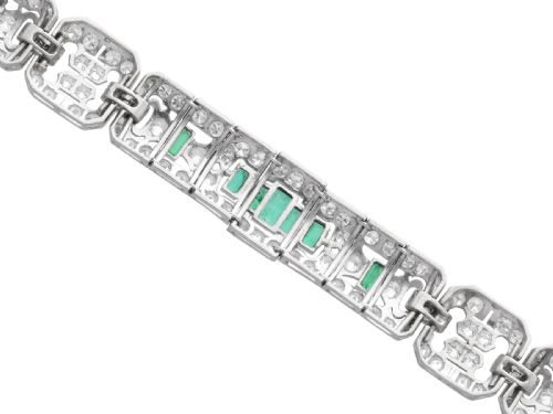 fig 7. An Art Deco platinum strap bracelet featuring geometric links set with diamonds and green accent emeralds.
