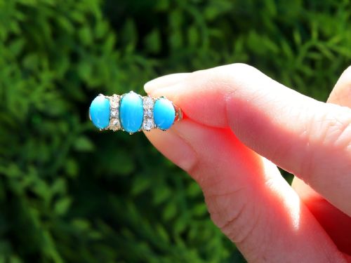 fig 1. A late Victorian 15ct yellow gold ring featuring three oval turquoise cabochons separated by small diamond accents.