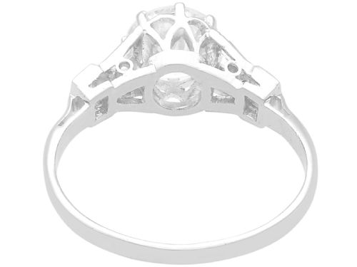 fig 5. An Art Deco platinum ring featuring a central round solitaire diamond flanked by geometric baguette-cut diamond shoulders.
