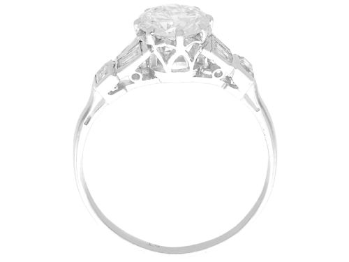 fig 6. An Art Deco platinum ring featuring a central round solitaire diamond flanked by geometric baguette-cut diamond shoulders.