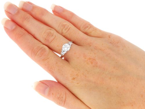 fig 8. An Art Deco platinum ring featuring a central round solitaire diamond flanked by geometric baguette-cut diamond shoulders.