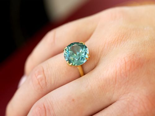 fig 2. An Edwardian 18ct yellow gold solitaire ring mounted with a round brilliant cut vibrant blue zircon in a claw setting.