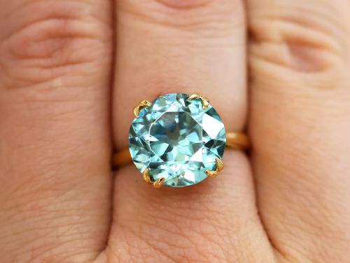 fig 4. An Edwardian 18ct yellow gold solitaire ring mounted with a round brilliant cut vibrant blue zircon in a claw setting.