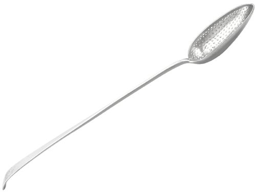 fig 2. An 18th-century sterling silver gravy straining spoon in the Old English pattern with a perforated bowl partition and engraved terminal monogram.