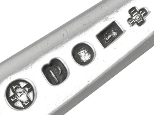 fig 4. An 18th-century sterling silver gravy straining spoon in the Old English pattern with a perforated bowl partition and engraved terminal monogram.