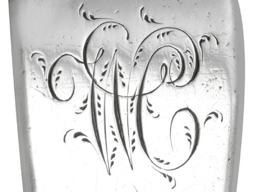 fig 5. An 18th-century sterling silver gravy straining spoon in the Old English pattern with a perforated bowl partition and engraved terminal monogram.