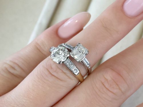 fig 2. A round central diamond solitaire ring in a platinum claw setting with diamond-set shoulders on a 14ct yellow gold band.
