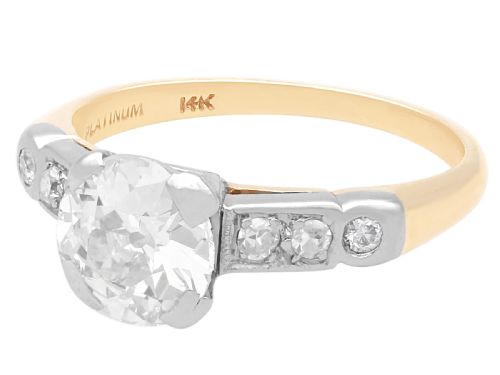 fig 5. A round central diamond solitaire ring in a platinum claw setting with diamond-set shoulders on a 14ct yellow gold band.