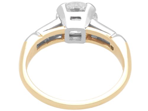 fig 6. A round central diamond solitaire ring in a platinum claw setting with diamond-set shoulders on a 14ct yellow gold band.