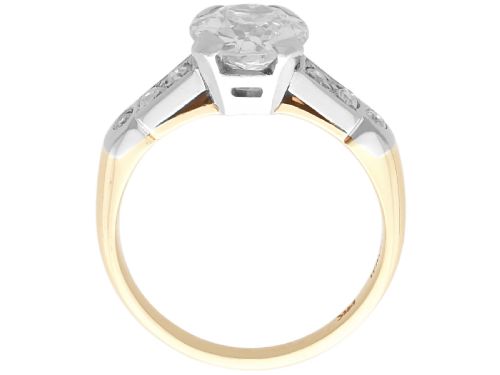 fig 7. A round central diamond solitaire ring in a platinum claw setting with diamond-set shoulders on a 14ct yellow gold band.
