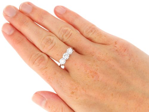 fig 7. A platinum trilogy ring featuring three round brilliant diamonds set in individual claw mounts along a slender polished band stamped PLAT.