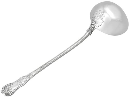 fig 2. An antique Victorian sterling silver soup ladle in Queens pattern featuring a deep round bowl and an intricately carved handle.