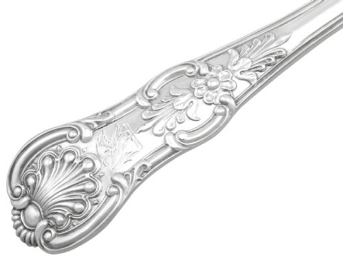 fig 3. An antique Victorian sterling silver soup ladle in Queens pattern featuring a deep round bowl and an intricately carved handle.