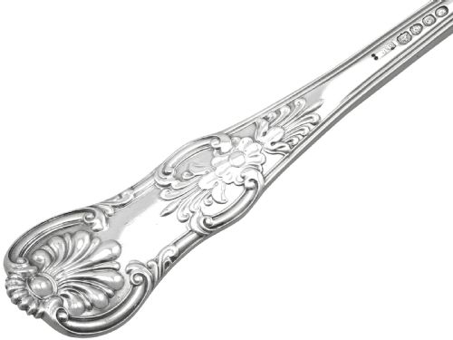 fig 4. An antique Victorian sterling silver soup ladle in Queens pattern featuring a deep round bowl and an intricately carved handle.