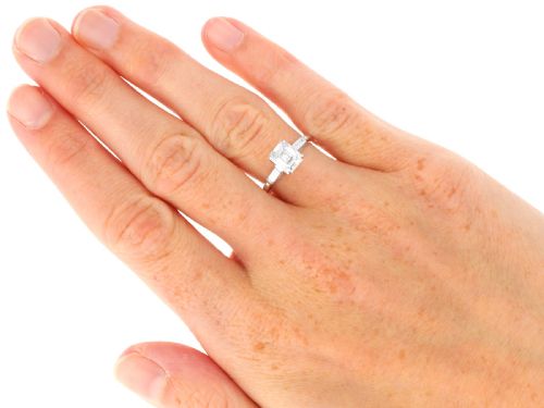 fig 7. A platinum solitaire ring featuring a central square step-cut diamond flanked by two baguette diamonds on a plain band.