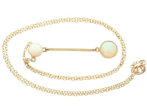 fig 3. Late Victorian 15ct yellow gold lavaliere necklace featuring two bezel-set round opal cabochons linked by a straight gold bar.