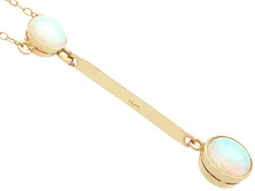 fig 4. Late Victorian 15ct yellow gold lavaliere necklace featuring two bezel-set round opal cabochons linked by a straight gold bar.