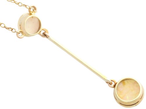 fig 5. Late Victorian 15ct yellow gold lavaliere necklace featuring two bezel-set round opal cabochons linked by a straight gold bar.
