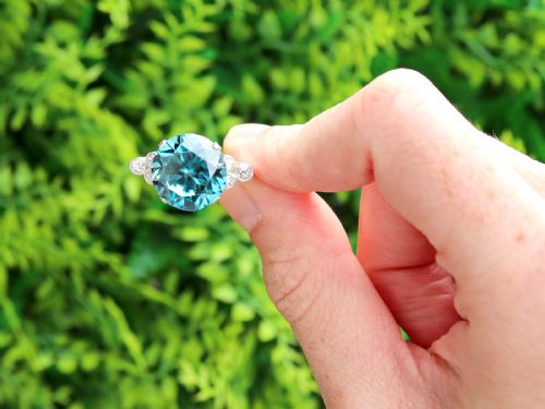 fig 1. An Art Deco 9ct yellow gold ring featuring a large round-cut blue zircon flanked by diamond-set shoulders.