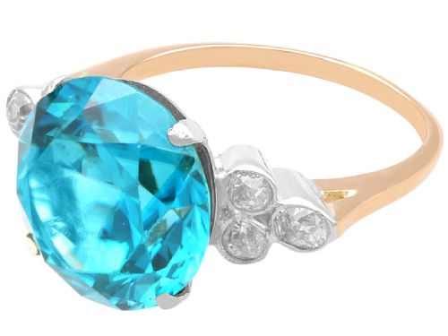fig 4. An Art Deco 9ct yellow gold ring featuring a large round-cut blue zircon flanked by diamond-set shoulders.