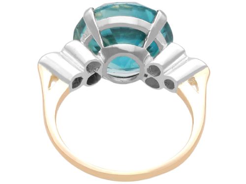 fig 5. An Art Deco 9ct yellow gold ring featuring a large round-cut blue zircon flanked by diamond-set shoulders.