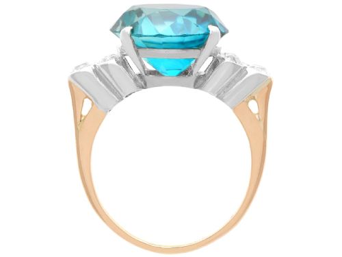 fig 6. An Art Deco 9ct yellow gold ring featuring a large round-cut blue zircon flanked by diamond-set shoulders.