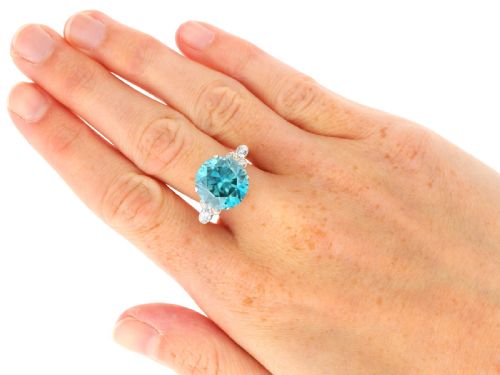 fig 8. An Art Deco 9ct yellow gold ring featuring a large round-cut blue zircon flanked by diamond-set shoulders.