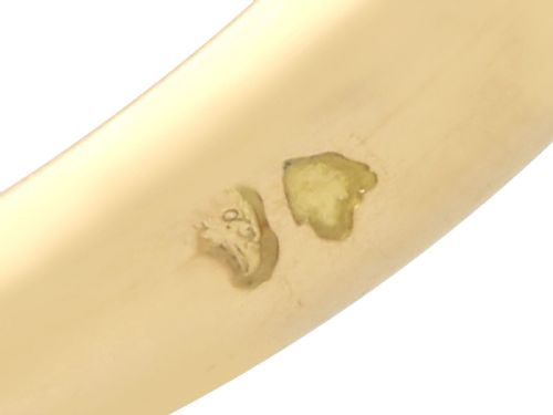 fig 8. A vintage 18ct yellow gold ring featuring a central round cream cultured pearl flanked by two triangular diamonds.