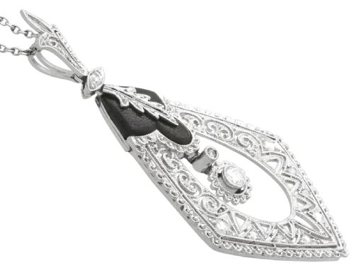 fig 5. A diamond-shaped Art Deco platinum filigree pendant set with carved black onyx and a central suspended diamond drop.