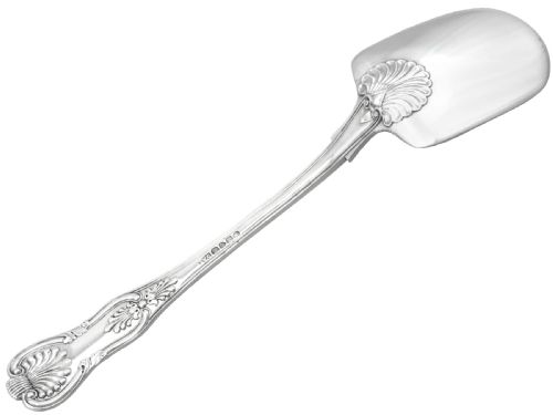 fig 2. An antique William IV sterling silver ice cream server featuring a broad shovel-shaped blade and a handle decorated with a shell motif.