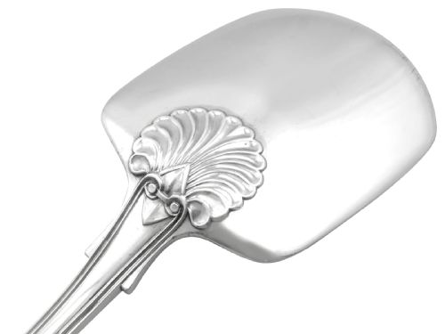 fig 3. An antique William IV sterling silver ice cream server featuring a broad shovel-shaped blade and a handle decorated with a shell motif.