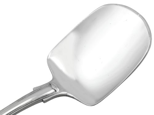 fig 4. An antique William IV sterling silver ice cream server featuring a broad shovel-shaped blade and a handle decorated with a shell motif.