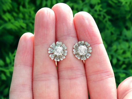 fig 1. Pair of late nineteenth-century floral cluster earrings featuring central cushion-cut diamonds surrounded by silver-set diamond petals with yellow gold fittings.