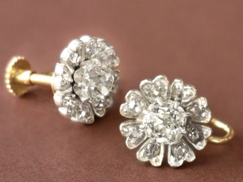 fig 3. Pair of late nineteenth-century floral cluster earrings featuring central cushion-cut diamonds surrounded by silver-set diamond petals with yellow gold fittings.