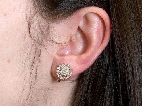 fig 8. Pair of late nineteenth-century floral cluster earrings featuring central cushion-cut diamonds surrounded by silver-set diamond petals with yellow gold fittings.