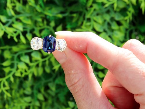 fig 1. An 18ct yellow gold Victorian trilogy ring set with a central cushion cut blue sapphire flanked by two round old cut diamonds.