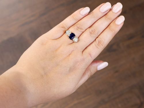 fig 2. An 18ct yellow gold Victorian trilogy ring set with a central cushion cut blue sapphire flanked by two round old cut diamonds.