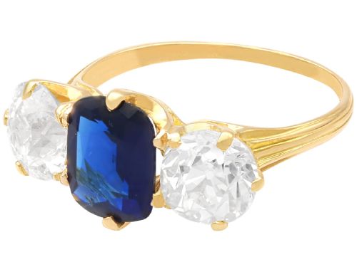 fig 4. An 18ct yellow gold Victorian trilogy ring set with a central cushion cut blue sapphire flanked by two round old cut diamonds.