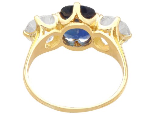 fig 5. An 18ct yellow gold Victorian trilogy ring set with a central cushion cut blue sapphire flanked by two round old cut diamonds.