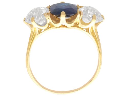 fig 6. An 18ct yellow gold Victorian trilogy ring set with a central cushion cut blue sapphire flanked by two round old cut diamonds.
