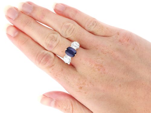 fig 7. An 18ct yellow gold Victorian trilogy ring set with a central cushion cut blue sapphire flanked by two round old cut diamonds.