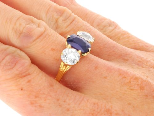 fig 8. An 18ct yellow gold Victorian trilogy ring set with a central cushion cut blue sapphire flanked by two round old cut diamonds.