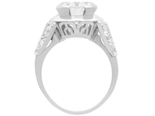 fig 4. An Art Deco platinum ring featuring a central round diamond set in a smooth bezel with accent diamonds on the shoulders.