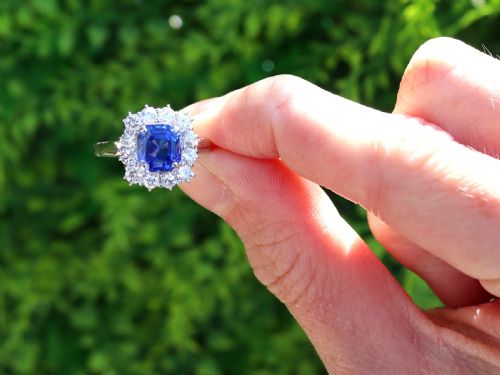 fig 1. A vintage platinum dress ring featuring a cushion-cut blue Ceylon sapphire surrounded by a cluster of round brilliant-cut diamonds.