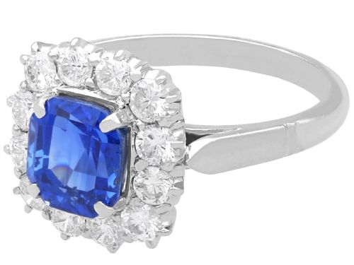fig 4. A vintage platinum dress ring featuring a cushion-cut blue Ceylon sapphire surrounded by a cluster of round brilliant-cut diamonds.