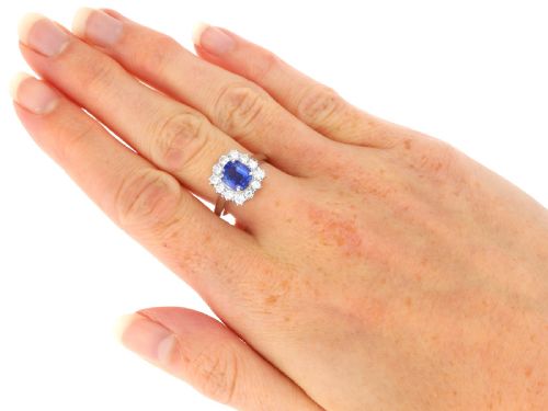 fig 7. A vintage platinum dress ring featuring a cushion-cut blue Ceylon sapphire surrounded by a cluster of round brilliant-cut diamonds.